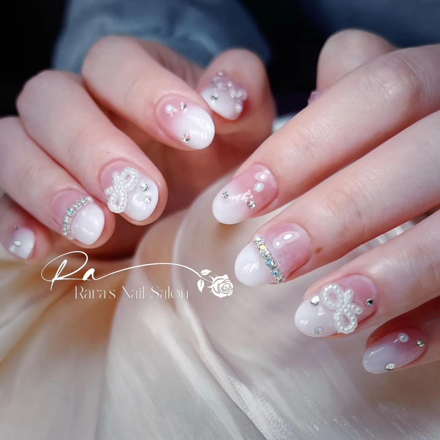 淡いピンクをベースカラーにしたネイルデザインは、優美さと気品...